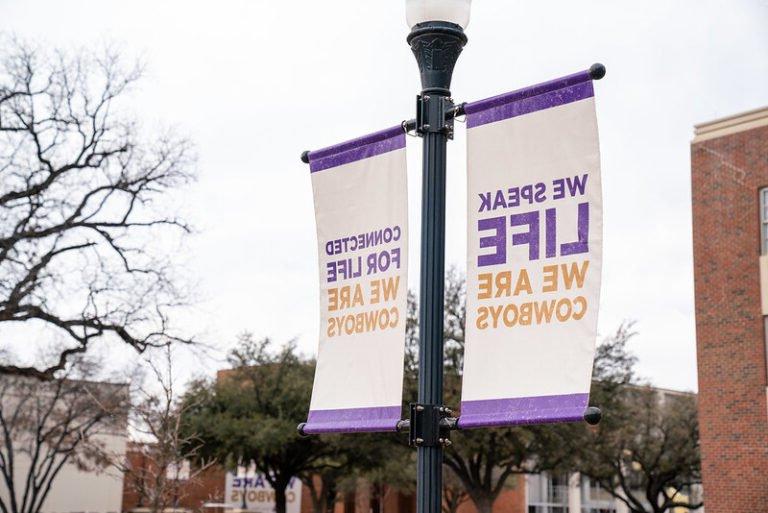 Campus banners say, "We speak LIFE, We are COWBOYS."
